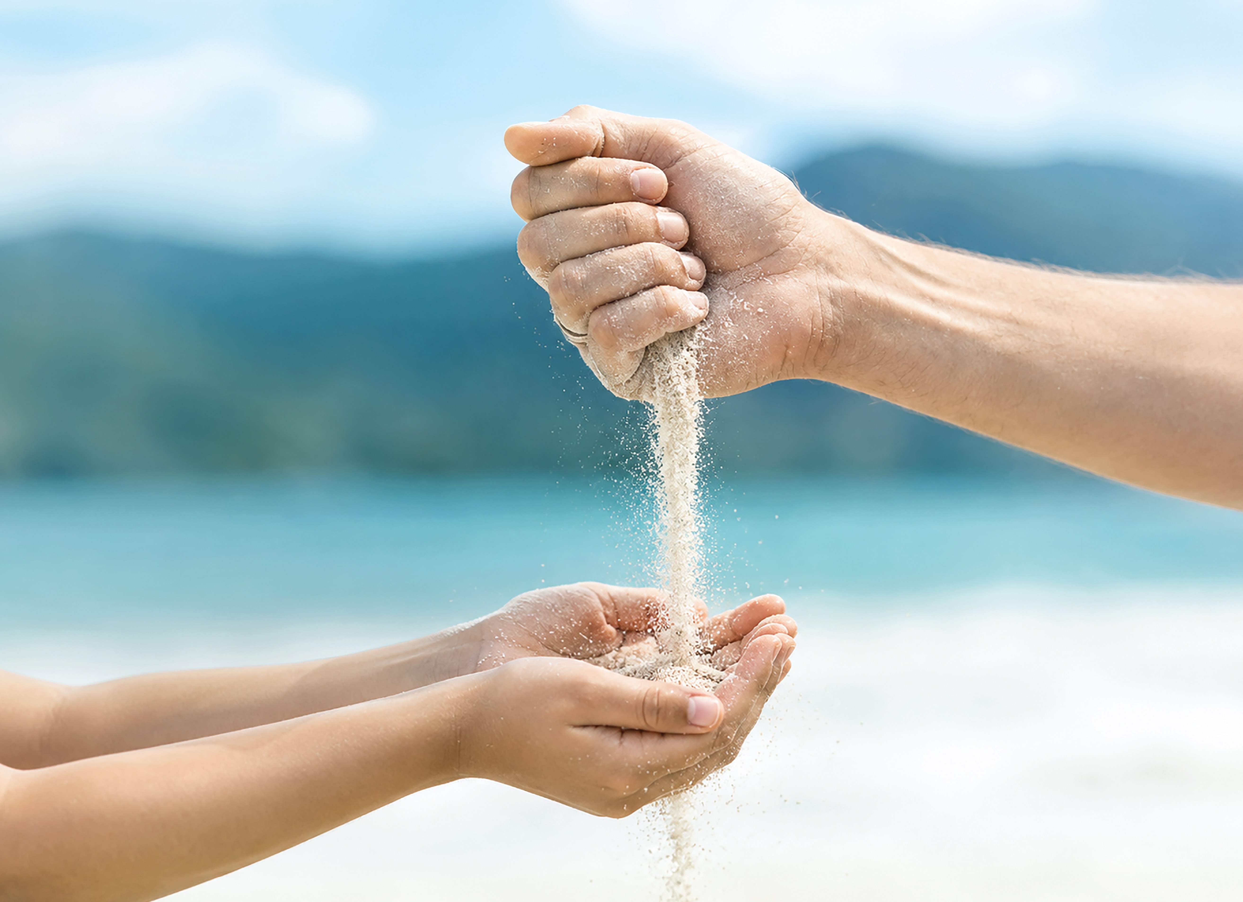 Sand passing from one generation's hands to the next